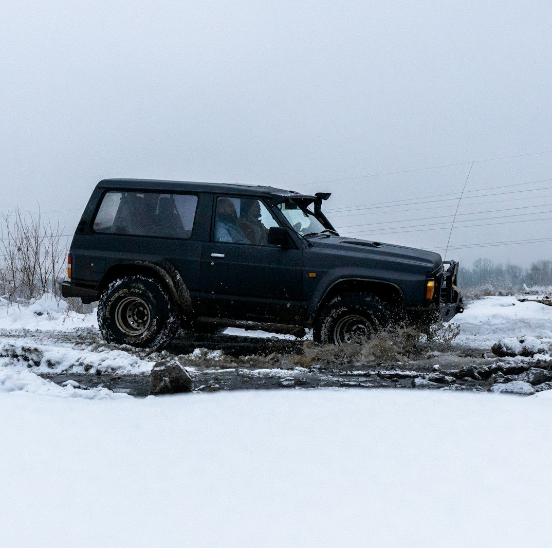 a jeep driving through a puddle in the snow vehicle recovery